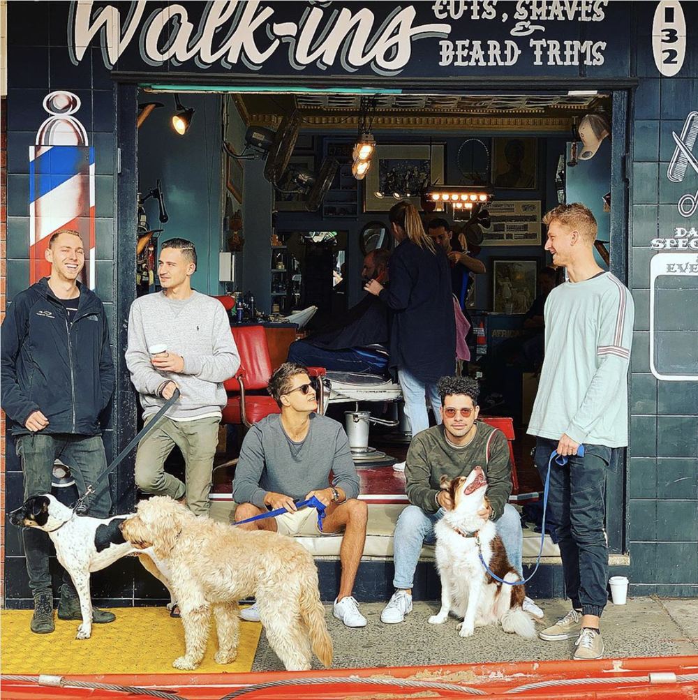 Regulars and their dogs gathered outside the Badlambs shopfront at 132 Glenayr Avenue, Bondi Beach, under the hand-painted Walk-ins sign